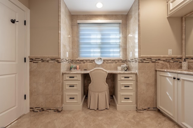 bathroom with tile patterned flooring, vanity, and tile walls