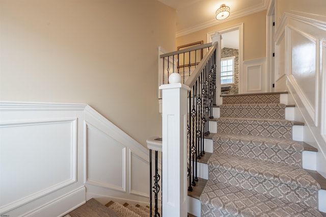 stairs featuring crown molding