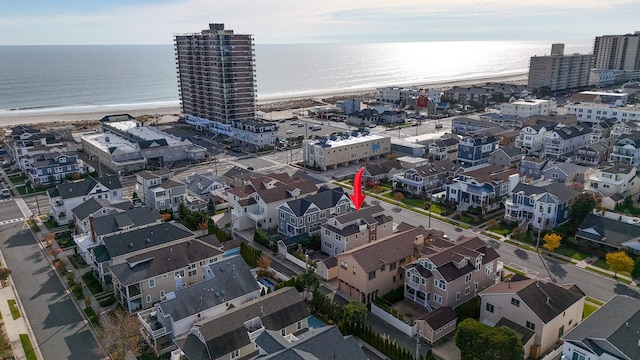 bird's eye view with a water view and a beach view