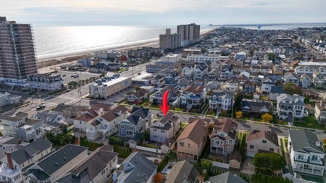 drone / aerial view with a water view and a view of the beach