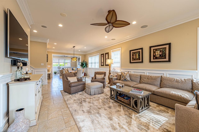 living room with ceiling fan and crown molding