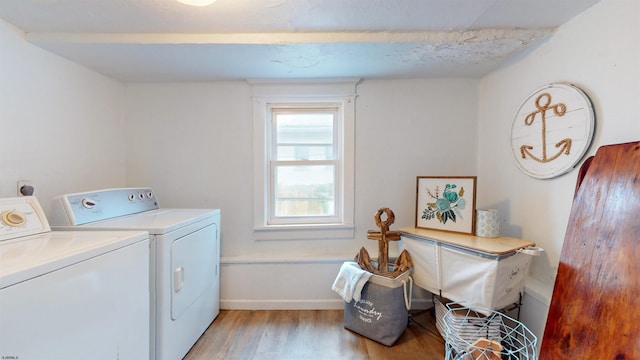 laundry area featuring washer and clothes dryer and light wood-type flooring