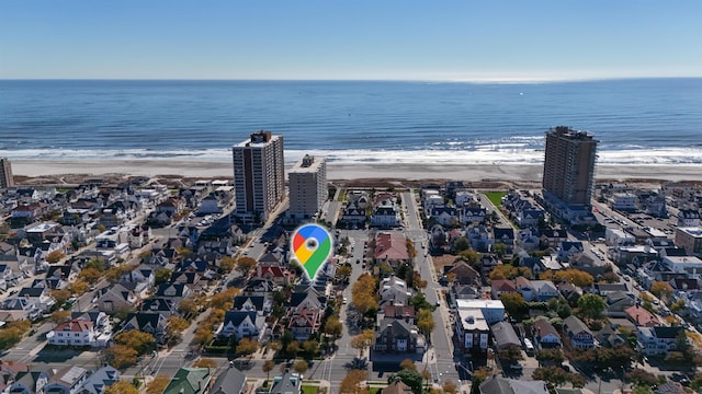 birds eye view of property with a view of the beach and a water view