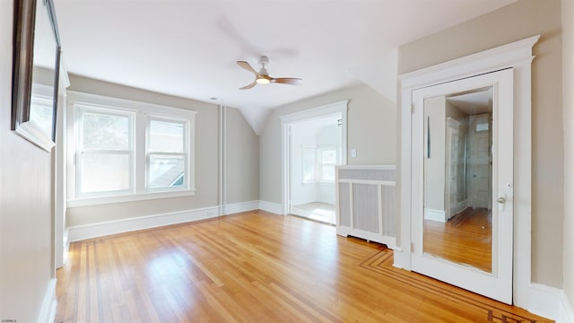 bonus room with radiator, ceiling fan, and light hardwood / wood-style flooring