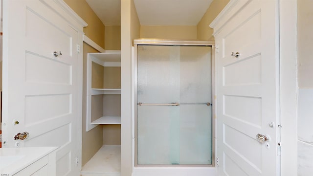 bathroom with a shower with door