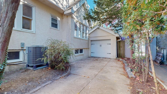 view of side of property featuring a garage and central air condition unit