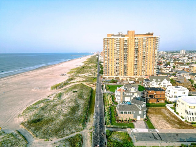 drone / aerial view featuring a water view and a beach view