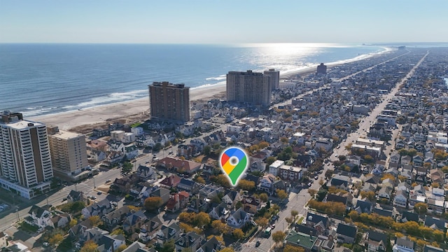 bird's eye view featuring a view of the beach and a water view