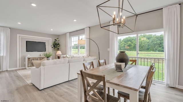 dining area with a chandelier and light wood-type flooring