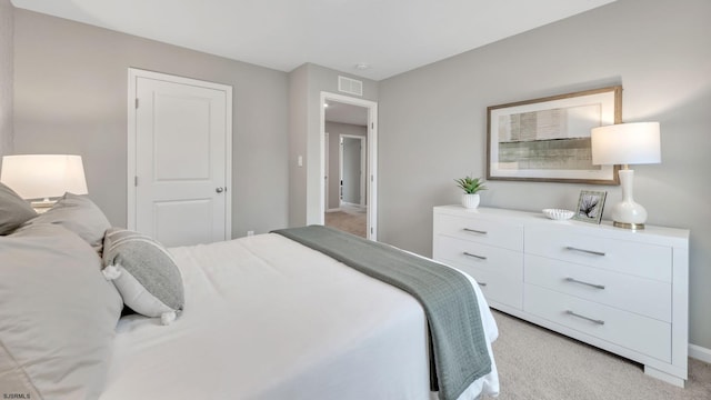 bedroom with light colored carpet