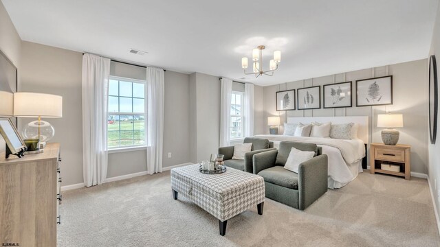 bedroom with light colored carpet, multiple windows, and a notable chandelier