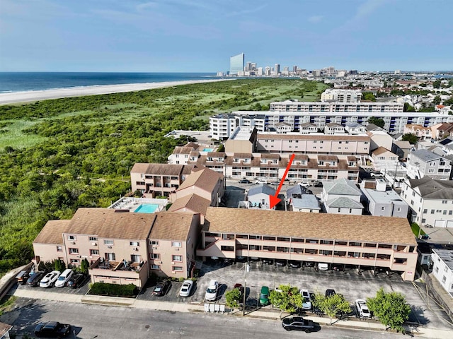 bird's eye view featuring a water view and a beach view