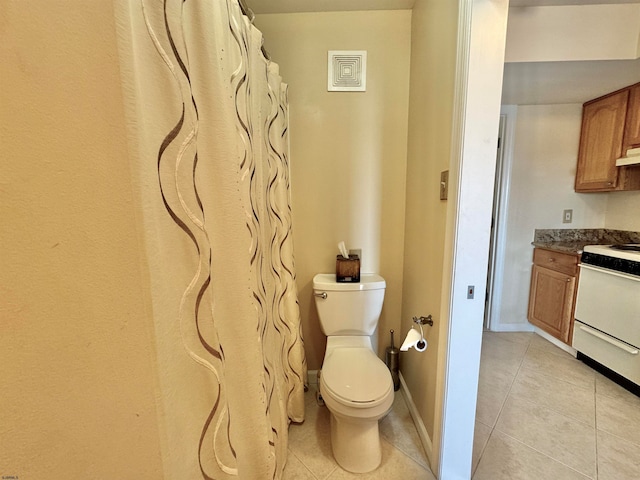 bathroom with tile patterned flooring, vanity, and toilet