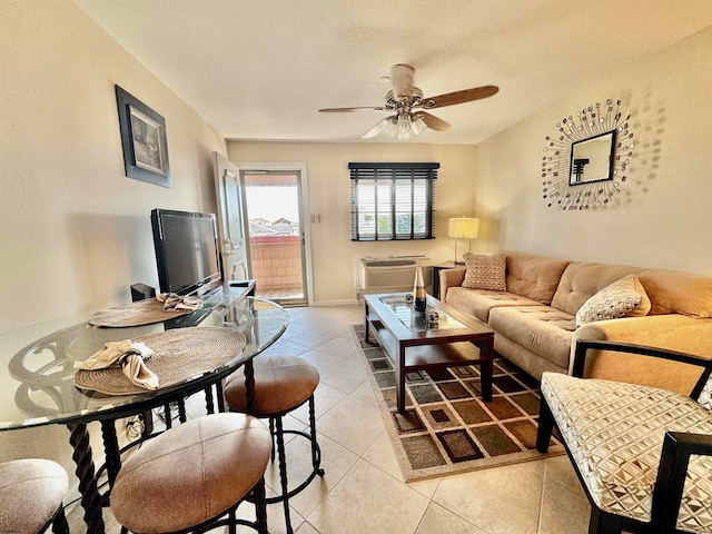 tiled living room featuring a wall unit AC and ceiling fan