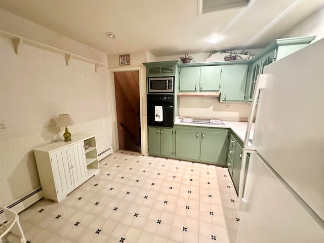 kitchen featuring white appliances, a baseboard radiator, and green cabinetry