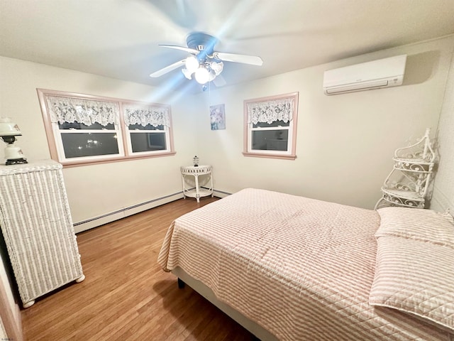 bedroom featuring ceiling fan, a baseboard radiator, a wall unit AC, and light hardwood / wood-style flooring