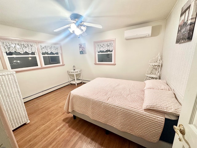 bedroom featuring a wall unit AC, ceiling fan, light hardwood / wood-style flooring, and a baseboard heating unit