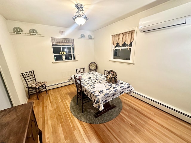 dining area with baseboard heating, hardwood / wood-style floors, and a wall mounted air conditioner