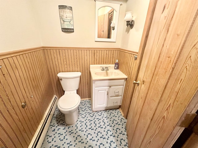 bathroom featuring vanity, toilet, and a baseboard heating unit