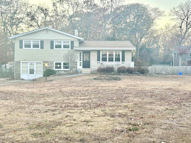 split level home featuring a front yard and covered porch