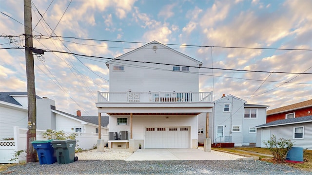 view of front of home with a balcony and a garage