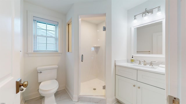 bathroom with vanity, toilet, and a shower with door