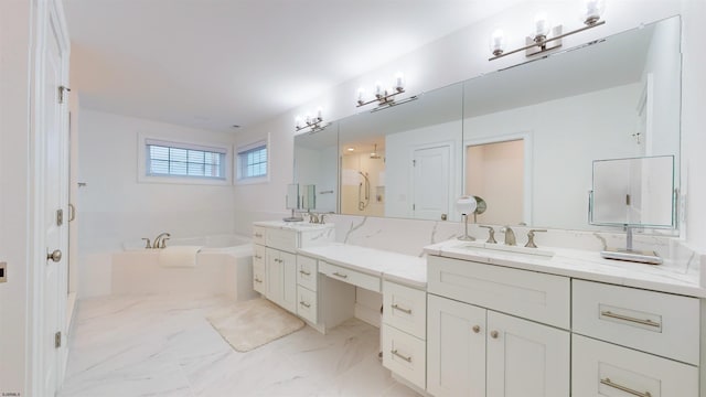 bathroom featuring vanity and a bath