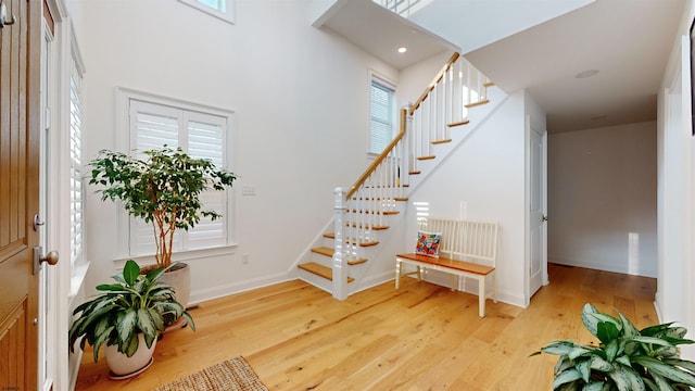 stairs featuring hardwood / wood-style floors