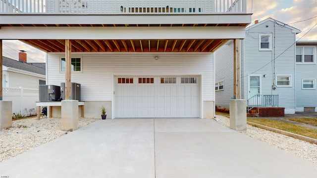 view of front facade with a balcony, a carport, and central air condition unit