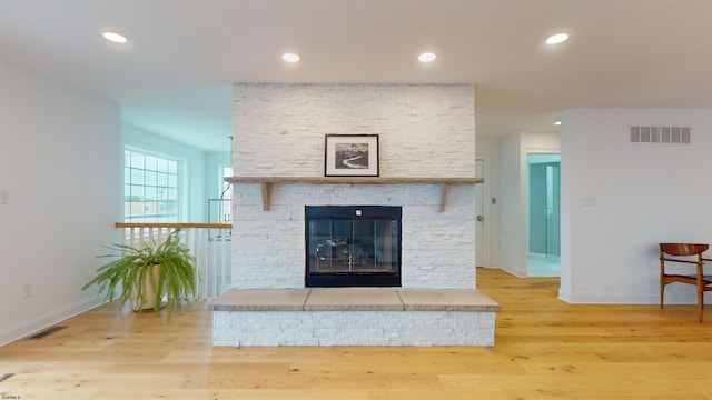 details with a fireplace and wood-type flooring