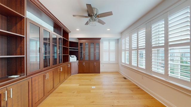 interior space with ceiling fan and light hardwood / wood-style floors