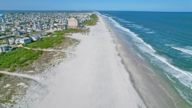 bird's eye view featuring a view of the beach and a water view