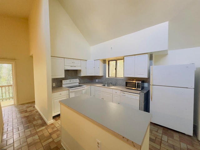 kitchen featuring white cabinetry, sink, high vaulted ceiling, backsplash, and white appliances