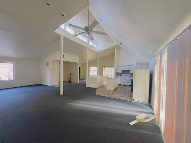 unfurnished living room featuring light carpet, high vaulted ceiling, and ceiling fan