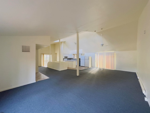 carpeted spare room featuring ceiling fan and vaulted ceiling