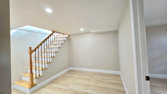 stairway with hardwood / wood-style floors