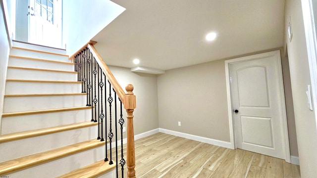 stairway featuring wood-type flooring