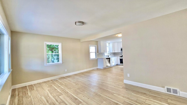 unfurnished living room with light hardwood / wood-style flooring