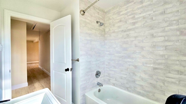 bathroom featuring hardwood / wood-style floors and tiled shower / bath