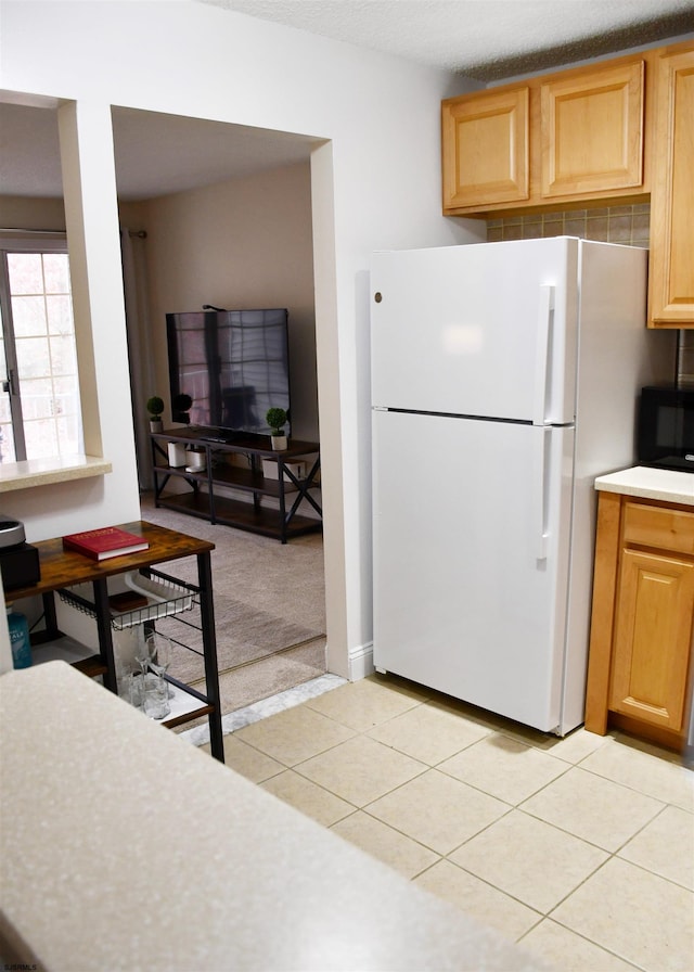 kitchen featuring white fridge and light tile patterned floors