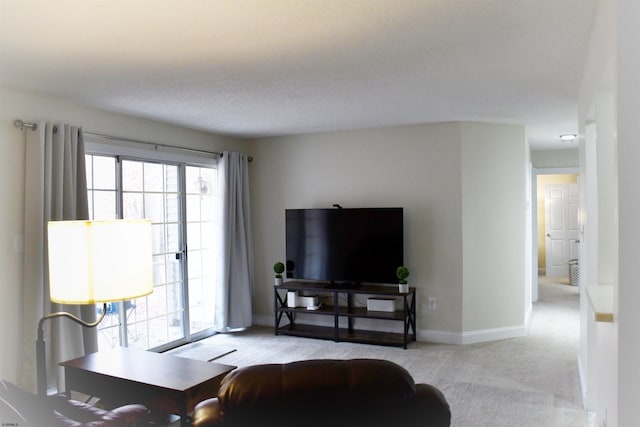 living room featuring light carpet and a textured ceiling