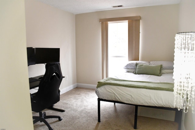 carpeted bedroom with a textured ceiling