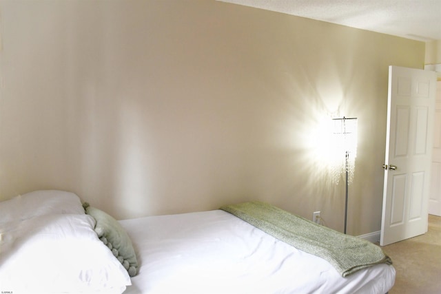 bedroom featuring light carpet