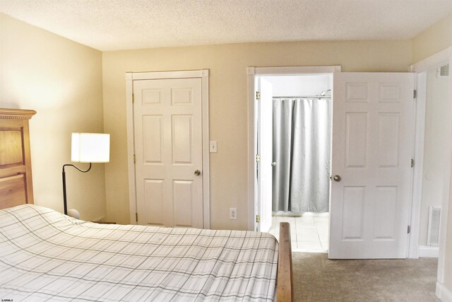 unfurnished bedroom with carpet flooring, a textured ceiling, and a closet