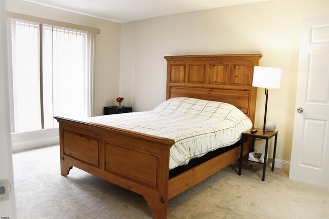 bedroom featuring light colored carpet