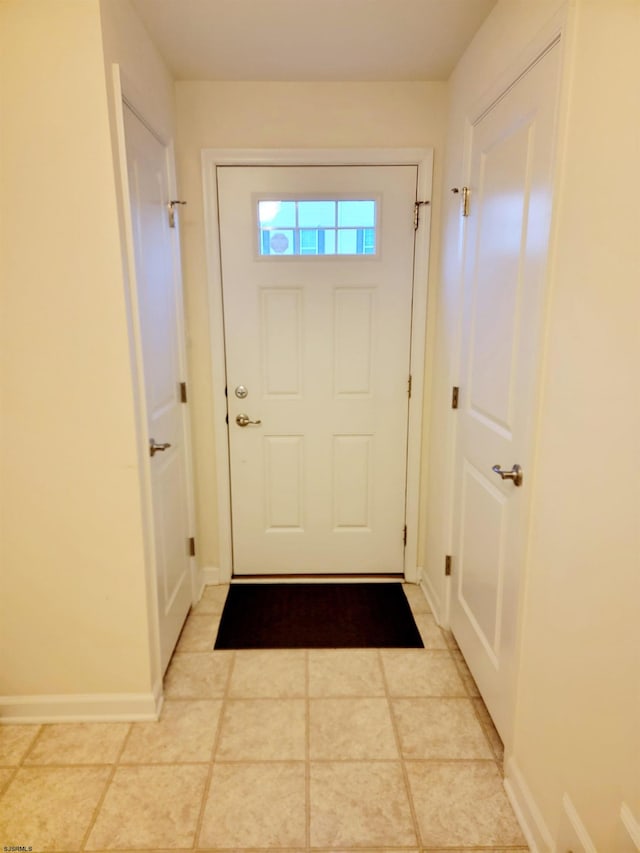 doorway to outside with light tile patterned floors