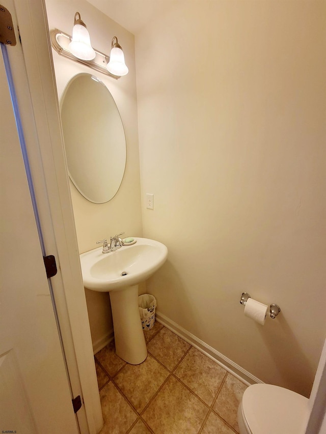 bathroom with tile patterned flooring and toilet