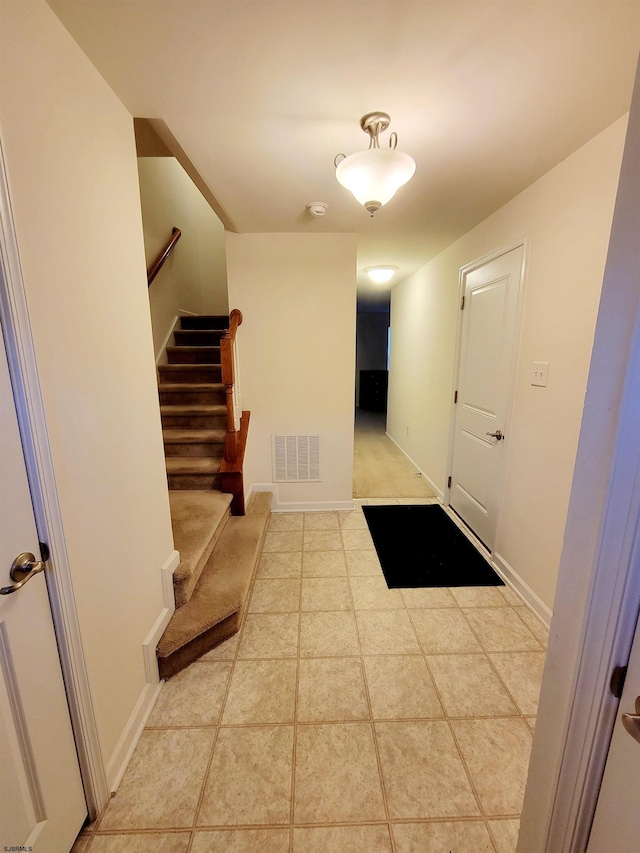 hall featuring light tile patterned flooring