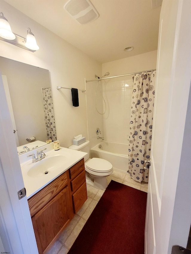 full bathroom with tile patterned floors, shower / bath combo with shower curtain, vanity, and toilet