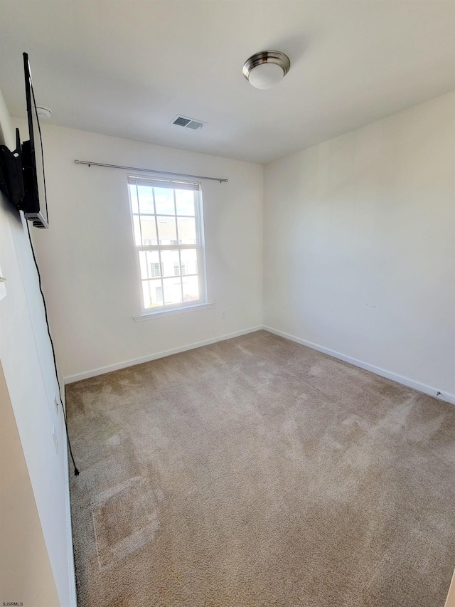 empty room featuring light colored carpet